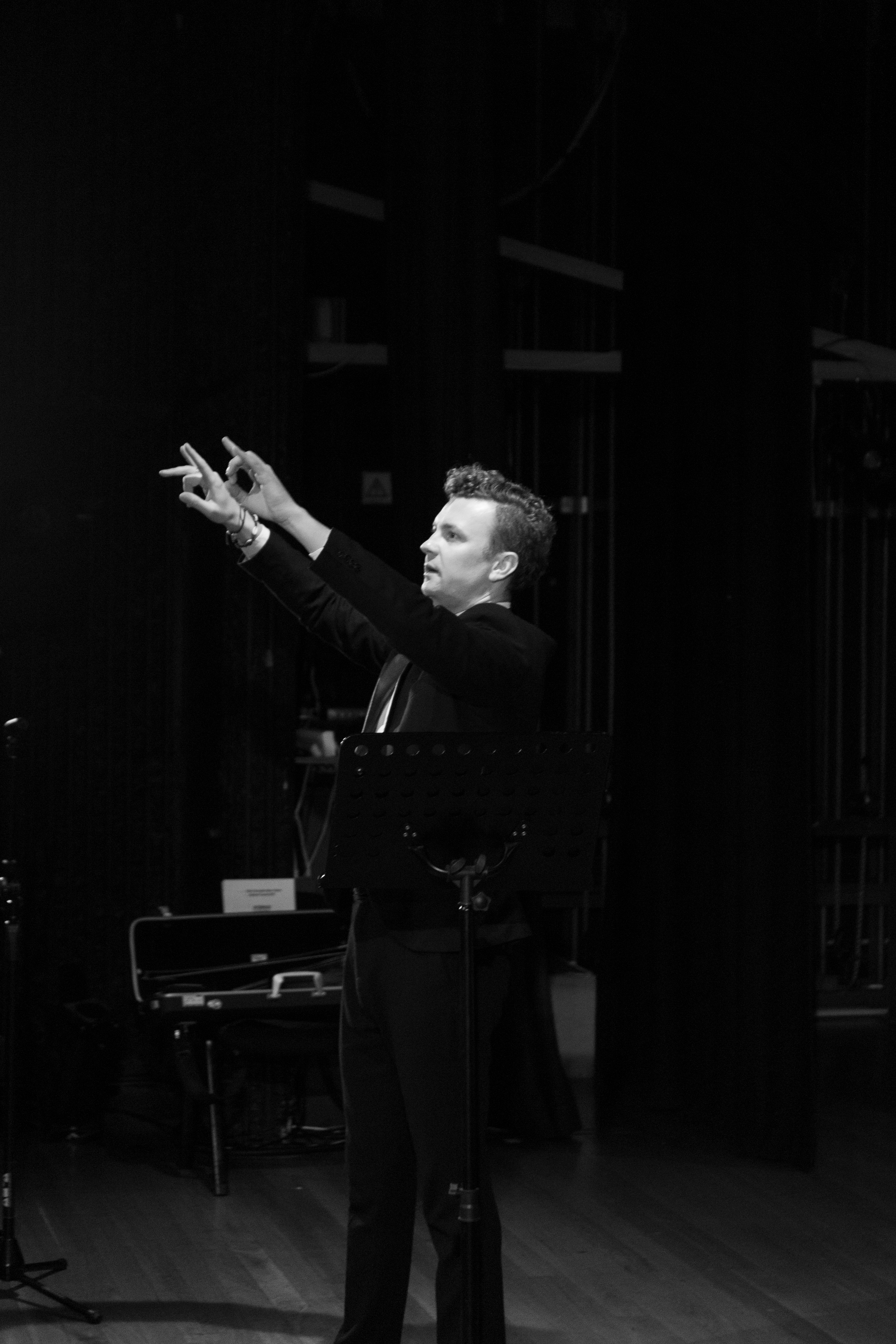 Dominik Przywara conducting, black and white