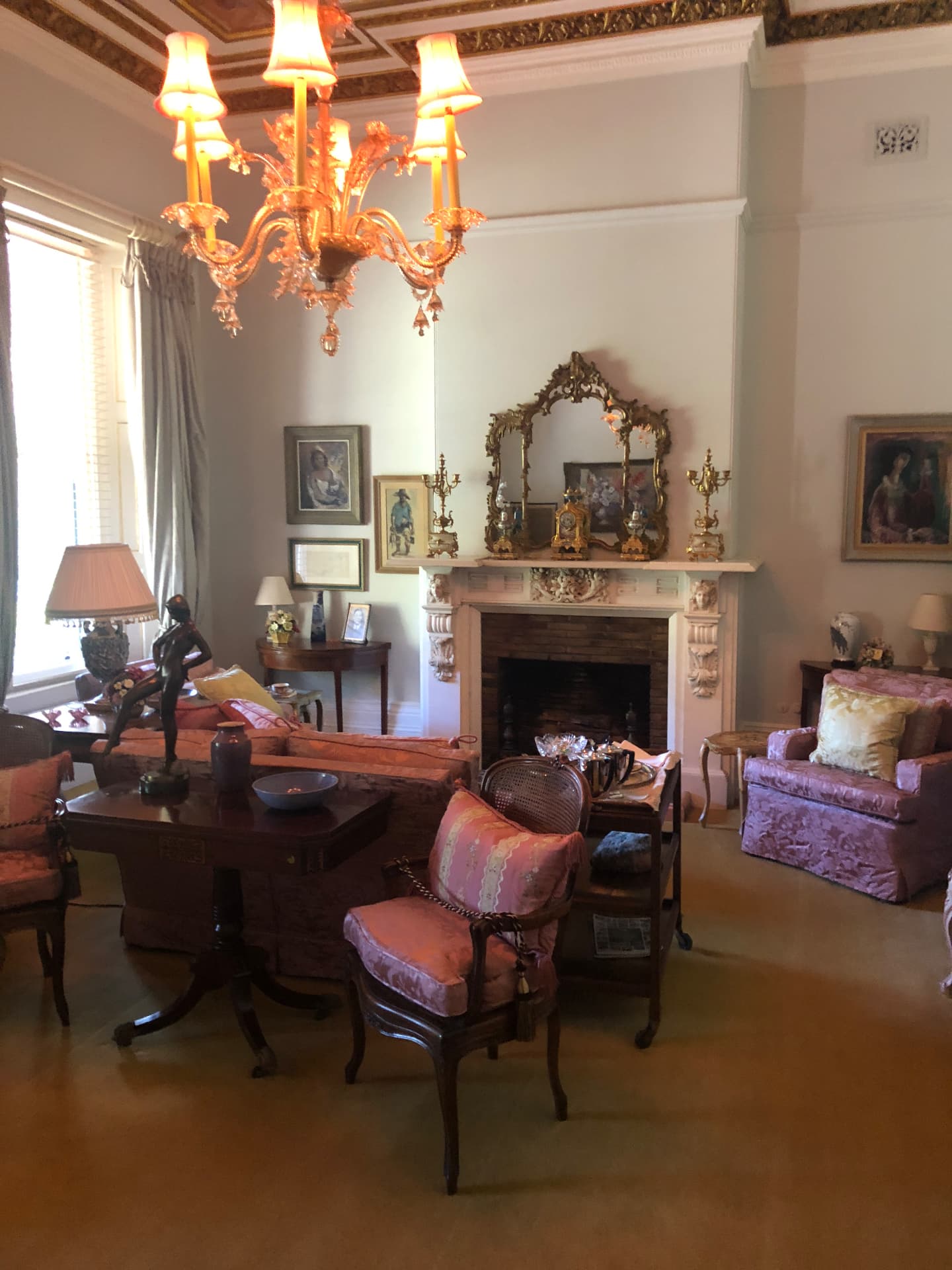Elegant drawing room with chandelier, fireplace and antique furniture